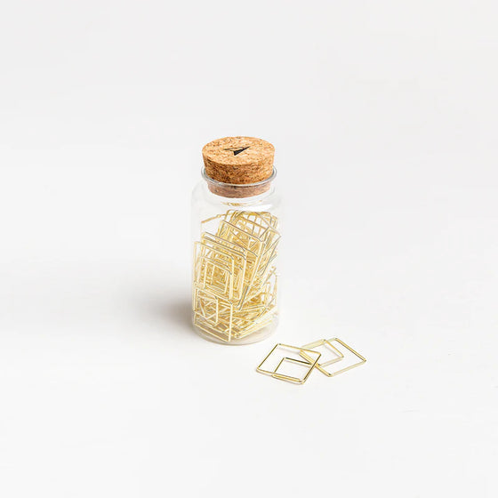 Χρυσοί συνδετήρες-σελιδοδείκτες σε βάζο - Somewhere